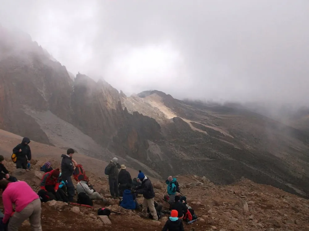 Our group resting on a rocky slope of Mount Kenya, in the cloud